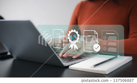 Quality Assurance and ISO Certification Concept with Business Woman Working on Laptop 137506887