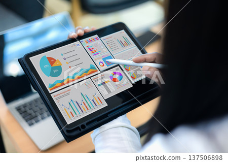 Close up of woman hand holding tablet with colorful business data analysis charts and financial dashboard. Concept of big data, digital marketing, investment strategy and business intelligence. Close up of woman hand holding tablet with colorful business data analysis charts and financial dashboard. Concept of big data, digital marketing, investment strategy and business intelligence. 137506898