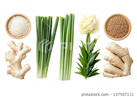 Assortment of Thai Herbal Compress Ingredients with Variety of Aromatic Herbs and Spices Including Ginger Galangal Lemongrass and Turmeric Roots and Leaves Displayed in Wooden Bowls 137507111