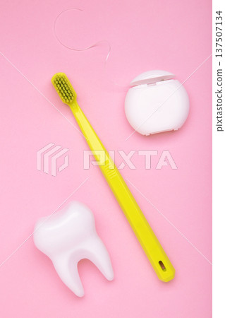 Mint toothbrushes with dental floss on pink background. Vertical photo Mint toothbrushes with dental floss on pink background. Vertical photo 137507134