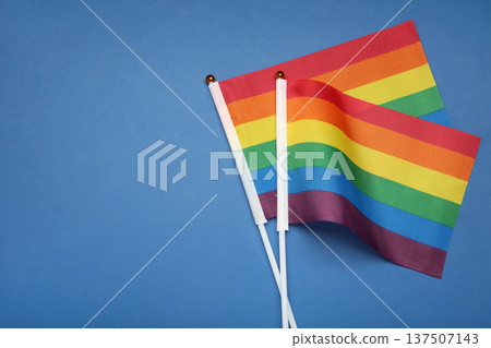 LGBT rainbow flag flat lay on blue background. Space for text 137507143