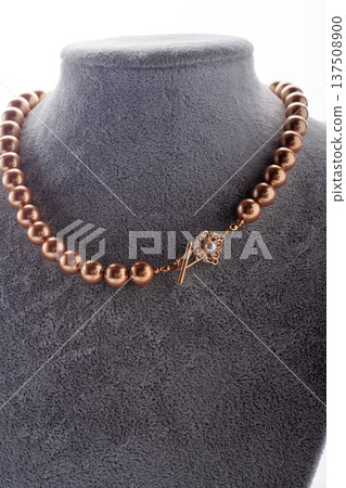 author handmade golden pearls necklace presented on maneken. fashion and jewelry concept. macro shot author handmade golden pearls necklace presented on maneken. fashion and jewelry concept. macro shot 137508900