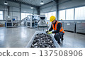 Worker sorts ewaste on conveyor belt. Recycling plant shows recycling process in recycling facility for Earth Day campaign, zero waste messaging, safety compliance, esg branding, copy space 137508906