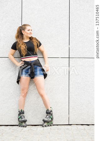 Young woman riding roller skates Young woman riding roller skates 137510465