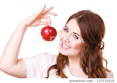Woman holds apple fruit close to face, isolated Woman holds apple fruit close to face, isolated 137510520