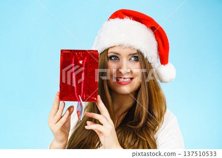 Happy Christmas woman holds red gift bag Happy Christmas woman holds red gift bag 137510533
