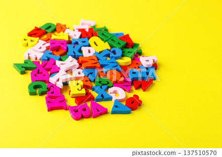 colored letters of the alphabet on a yellow background 137510570