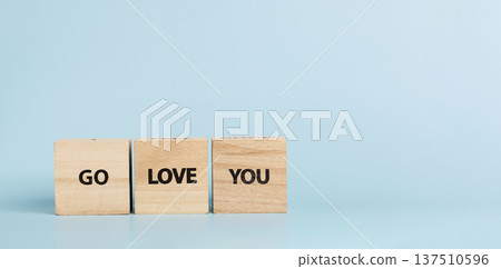 Wooden cubes with inscriptions Go Love You on a blue background 137510596