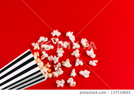 box with popcorn striped in different colors on a red background box with popcorn striped in different colors on a red background 137510601