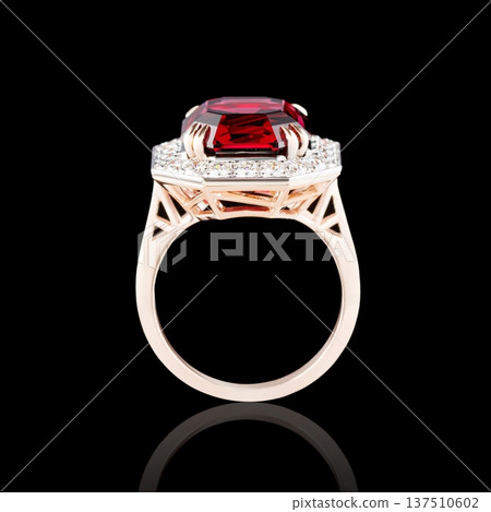 Beautiful red gold ring with diamonds and garnet on a black background Beautiful red gold ring with diamonds and garnet on a black background 137510602