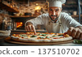 Male chef in white uniform and hat is preparing fresh pizza with toppings in a rustic kitchen, showcasing culinary skills and passion for cooking 137510702