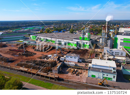 Woodworking plant, aerial view. Wood processing plant. Factory smoke stacks. Woodworking plant, aerial view. Wood processing plant. Factory smoke stacks. 137510724