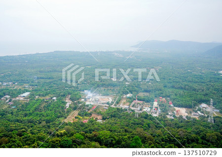 View from hilltop showing trees, buildings, jungle landscape and distance rural Phu Quoc . View from hilltop showing trees, buildings, jungle landscape and distance rural Phu Quoc . 137510729