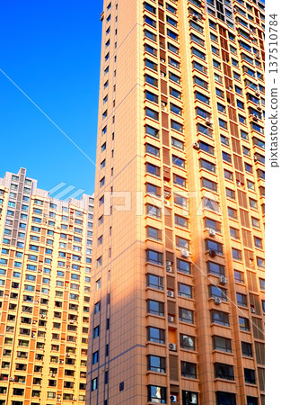 Glass tower building on blue sky background. Facade of new modern business office building. Glass tower building on blue sky background. Facade of new modern business office building. 137510784