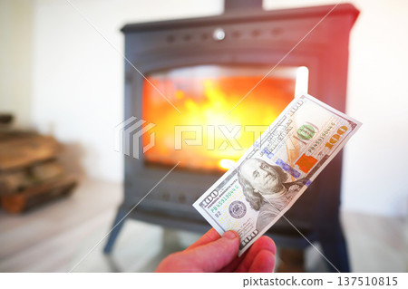 Heating payment. Save money wood stove. Dollar money banknotes for payment of heating firewood. Heating payment. Save money wood stove. Dollar money banknotes for payment of heating firewood. 137510815