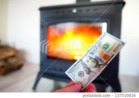 Heating payment. Save money wood stove. Dollar money banknotes for payment of heating firewood. Heating payment. Save money wood stove. Dollar money banknotes for payment of heating firewood. 137510816