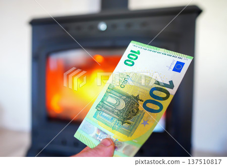 Heating payment. Save money wood stove. Euro money banknotes for payment of heating firewood Heating payment. Save money wood stove. Euro money banknotes for payment of heating firewood 137510817
