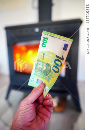 Heating payment. Save money wood stove. Euro money banknotes for payment of heating firewood Heating payment. Save money wood stove. Euro money banknotes for payment of heating firewood 137510818