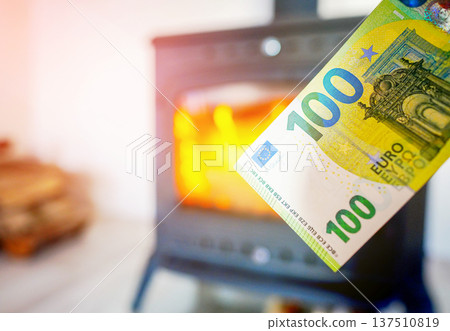 Heating payment. Save money wood stove. Euro money banknotes for payment of heating firewood Heating payment. Save money wood stove. Euro money banknotes for payment of heating firewood 137510819