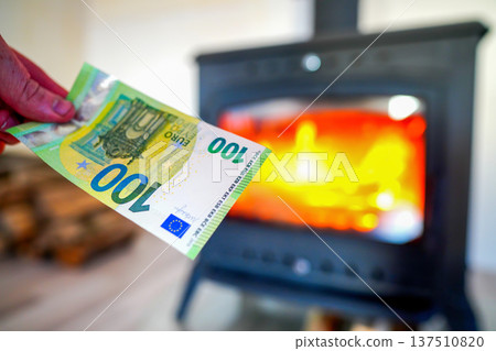 Heating payment. Save money wood stove. Euro money banknotes for payment of heating firewood Heating payment. Save money wood stove. Euro money banknotes for payment of heating firewood 137510820