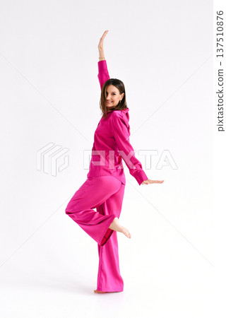 Woman Smiling In Pink Outfit Standing Gracefully Woman Smiling In Pink Outfit Standing Gracefully 137510876
