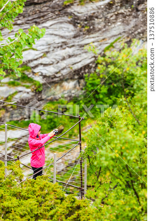 Tourist taking photo in mountains Norway Tourist taking photo in mountains Norway 137510886