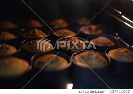 Cupcakes in oven in cookie cutters. Selective focus. 137511067