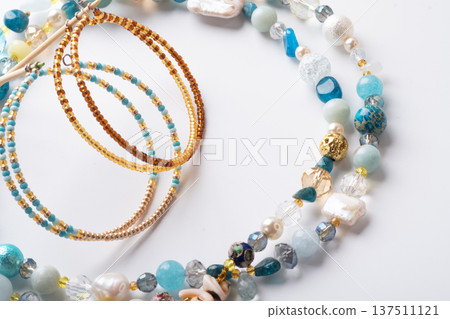 author trend necklace with different  beads  demonstrated  against white background. fashion and jewelry concept 137511121