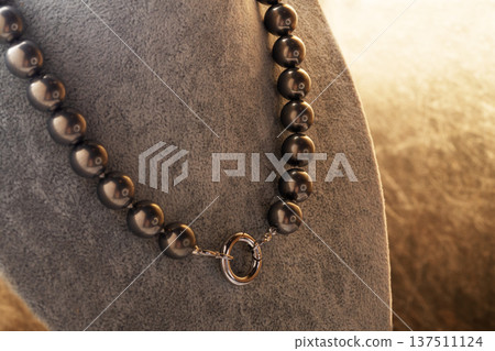 author beautiful steel color pearls necklaces with heart pendant demonstrated on maneken. fashion and jewelry concept author beautiful steel color pearls necklaces with heart pendant demonstrated on maneken. fashion and jewelry concept 137511124