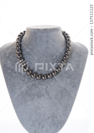 author beautiful steel color pearls necklaces with heart pendant demonstrated on maneken. fashion and jewelry concept author beautiful steel color pearls necklaces with heart pendant demonstrated on maneken. fashion and jewelry concept 137511125
