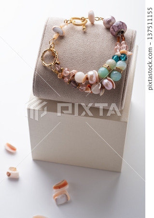 author gold plated bracelete with pearls and gemstones demonstrated against white background. fashion and jewelry concept author gold plated bracelete with pearls and gemstones demonstrated against white background. fashion and jewelry concept 137511155