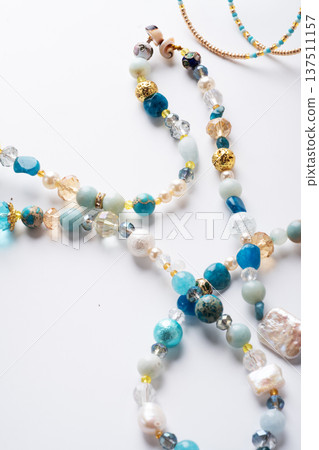author trend necklace with different beads demonstrated against white background. fashion and jewelry concept author trend necklace with different beads demonstrated against white background. fashion and jewelry concept 137511157
