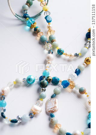 author trend necklace with different beads demonstrated against white background. fashion and jewelry concept author trend necklace with different beads demonstrated against white background. fashion and jewelry concept 137511158