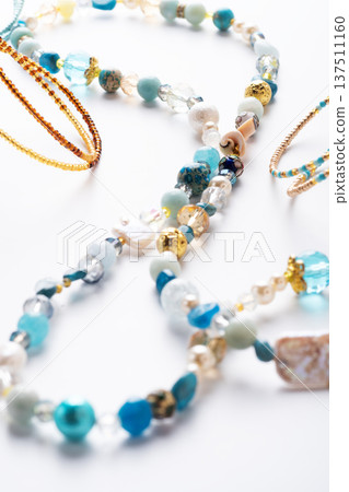 author trend necklace with different beads demonstrated against white background. fashion and jewelry concept author trend necklace with different beads demonstrated against white background. fashion and jewelry concept 137511160