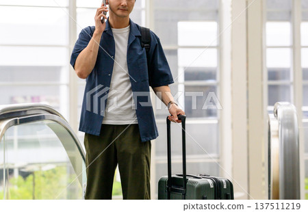 A man making a phone call at the airport. Photo courtesy of Kansai International Airport (KIX) A man making a phone call at the airport. Photo courtesy of Kansai International Airport (KIX) 137511219