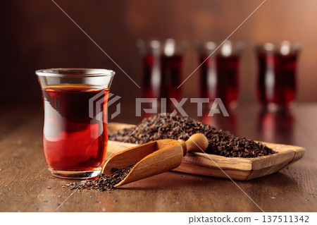 Black tea on an old wooden table. Black tea on an old wooden table. 137511342