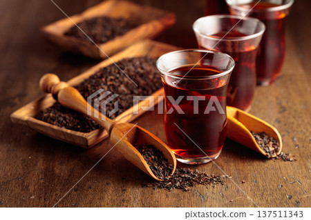 Black tea on an old wooden table. Black tea on an old wooden table. 137511343