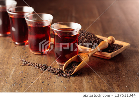 Black tea on an old wooden table. Black tea on an old wooden table. 137511344