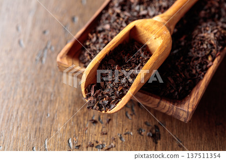 Black tea on an old wooden table. Black tea on an old wooden table. 137511354