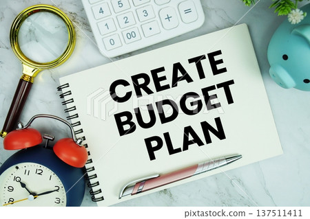 Create Budget Plan text written on notepad with piggy bank, calculator, magnifying glass and alarm clock on marble background Create Budget Plan text written on notepad with piggy bank, calculator, magnifying glass and alarm clock on marble background 137511411