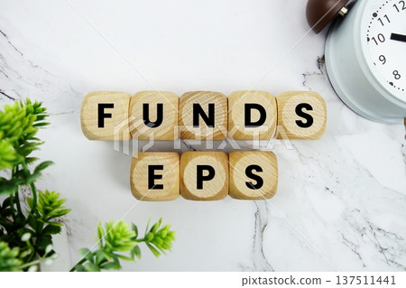 Funds EPS Mutual fund earnings analysis alphabet letters and alarm clock on marble background 137511441