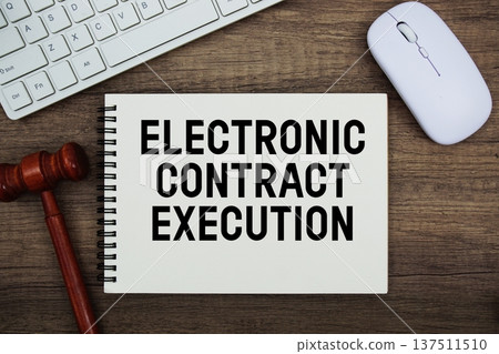 Electronic Contract Execution text written with gavel, keyboard and optical mouse on wooden background Electronic Contract Execution text written with gavel, keyboard and optical mouse on wooden background 137511510