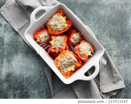 Stuffed red peppers with minced meat, rice, onion in baking dish Stuffed red peppers with minced meat, rice, onion in baking dish 137511547