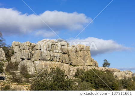 Rocks stand tall under a blue sky in El Torcal, Spain, on a clear day with clouds above Rocks stand tall under a blue sky in El Torcal, Spain, on a clear day with clouds above 137511661