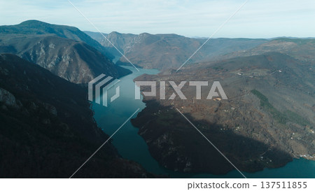 Aerial view of rocky cliffs and forested slopes in Tara National Park overlooking the Drina River and Perucac Lake during a snowless winter. Scenic natural landscape of western Serbia Aerial view of rocky cliffs and forested slopes in Tara National Park overlooking the Drina River and Perucac Lake during a snowless winter. Scenic natural landscape of western Serbia 137511855