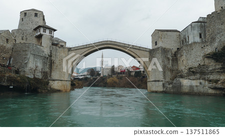 Iconic Stari Most bridge in Mostar spanning the turquoise Neretva River. Historic stone architecture reflects the cultural heritage and resilience of Bosnia and Herzegovina Iconic Stari Most bridge in Mostar spanning the turquoise Neretva River. Historic stone architecture reflects the cultural heritage and resilience of Bosnia and Herzegovina 137511865