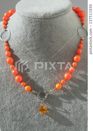 author beautiful fashionable necklace with neo orange pearls demonstrated at model. fashion and jewelry concept author beautiful fashionable necklace with neo orange pearls demonstrated at model. fashion and jewelry concept 137511930
