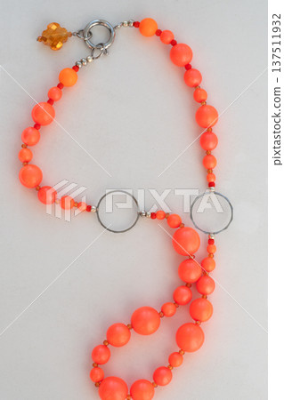 author beautiful fashionable necklace with neo orange pearlsl. fashion and jewelry concept. close up author beautiful fashionable necklace with neo orange pearlsl. fashion and jewelry concept. close up 137511932