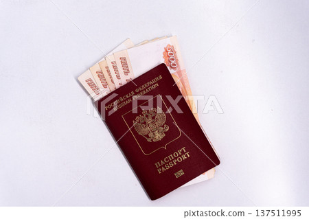Russian passport with 5000 ruble banknotes inside. Travel and finance concept with copy space Russian passport with 5000 ruble banknotes inside. Travel and finance concept with copy space 137511995