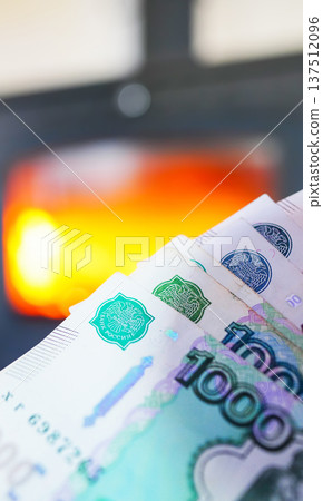 Heating payment. Save money wood stove. Russian ruble banknotes for payment of heating firewood. Heating payment. Save money wood stove. Russian ruble banknotes for payment of heating firewood. 137512096